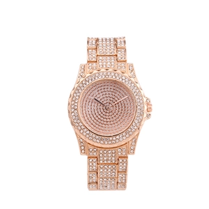 Detailed close-up of rose gold watch fully encrusted with shimmering white crystals