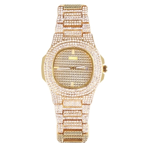 Vue détaillée du cadran carré doré avec strass luxueux et guichet de date