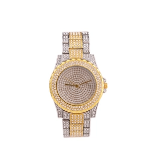 Detailed close-up of luxury gold and silver two-tone watch band fully paved with rhinestones