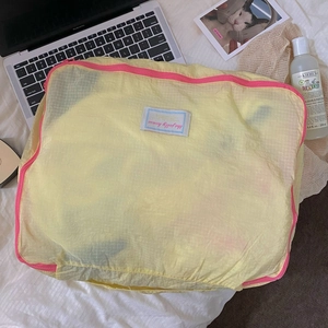 Macro view of water-resistant nylon travel organizer bag with mesh texture and pink zipper