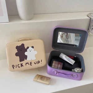 Detail view of large capacity makeup bag with built-in mirror and cream bear patterns