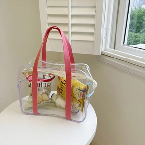 Transparent PVC tote bag with pink handles and purple trim for beach and bath use