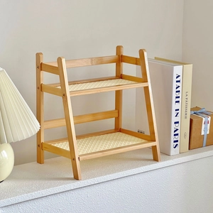 Detail of a two-tier cream rattan desktop storage shelf with natural bamboo frame