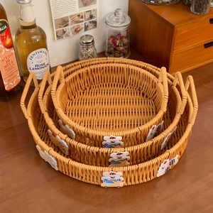 Nesting set of three round brown woven storage baskets with cute cartoon animal patches