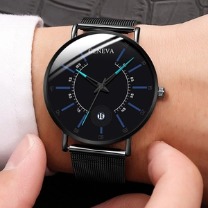 Detail of minimalist black quartz watch with mesh strap and date window on male wrist