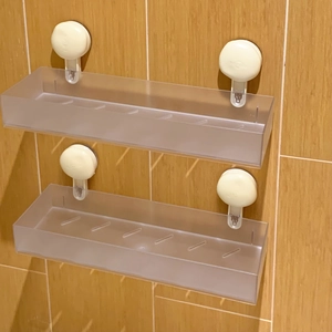 Detail showing two-piece transparent adhesive bathroom shelves with drainage grooves