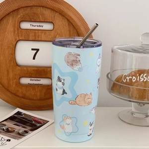 Close-up detail of the cute cartoon cat illustrations on a light blue insulated tumbler