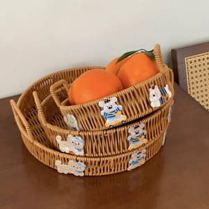 Detailed view of nested woven storage baskets with cute bear and cat cloth patches