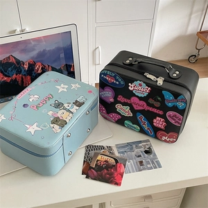 Close-up of cute cartoon puppy and vintage sticker patterns on large makeup cases
