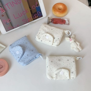 Mini fabric wallet with silver star patterns, snap button closure, and plush bunny charm