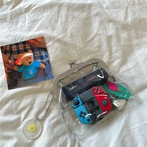 Detail of transparent PVC mini bag storing lipstick and earbuds with metal clip
