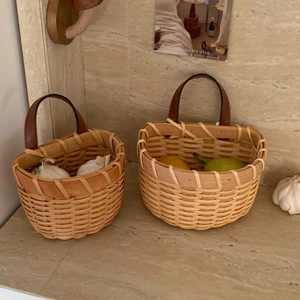 Handwoven kitchen storage baskets with leather handles for garlic and fruit organization