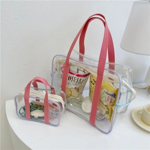 Close-up of clear PVC beach bag set with purple trim and interior storage display