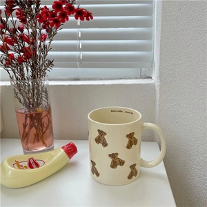 Close-up of ceramic bear mug with 'Better coffee, Better life' text inside the rim