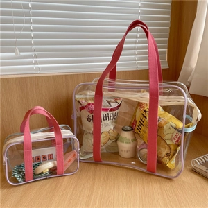 Macro view of transparent PVC waterproof beach bags with pink handles and purple trim