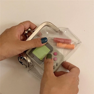 Macro view of transparent PVC coin purse with silver metal frame and retro clasp