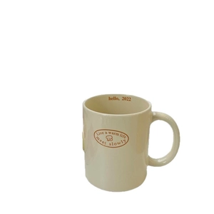 Cream vintage bear ceramic mug with handle and artistic brown lettering for breakfast
