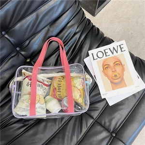 Detail view of pink transparent PVC beach bag showing spacious interior and handles