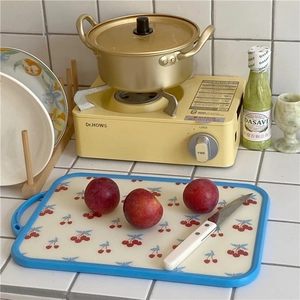 Light blue floral cutting board with cherry pattern and hanging hole for kitchen use