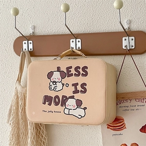 Detail of cream cosmetic bag with Less Is More text and cute puppy illustration