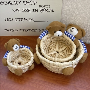 Detailed view of three sizes of handmade woven baskets with cute plush bear decorations