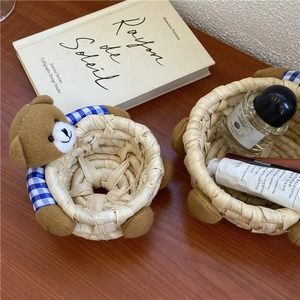Handwoven straw storage basket featuring a cute teddy bear decor for desktop organization