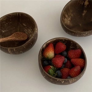 Natural coconut bowl set with wooden spoon for yogurt and salad on white background