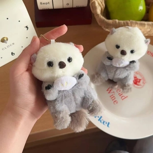 Cute plush sea otter keychain charm for backpacks with a golden metal bead chain