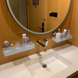 Light blue matte bathroom shelf with drainage slots and suction cup mounting on wall