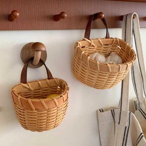 Detail showing handwoven wicker storage baskets with leather handles and lemons