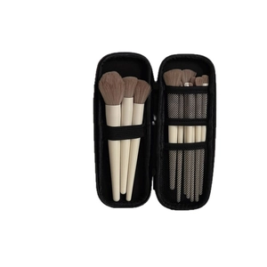 Portable makeup brush set with ivory handles and black zipper travel storage bag