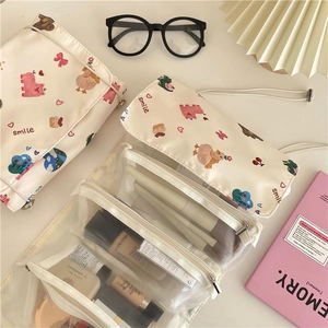 Detail view of foldable bear makeup bag with brush slots and mesh zipper compartments