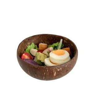 Natural coconut shell salad bowl with healthy fruit and vegetable mix on white background