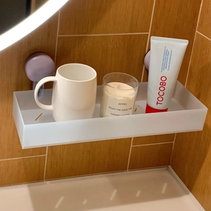 Close-up of translucent frosted bathroom shelf with suction cups and drainage holes