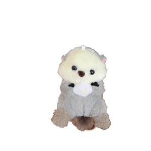 Cute plush sea otter keychain doll holding a white shell for backpacks and school bags