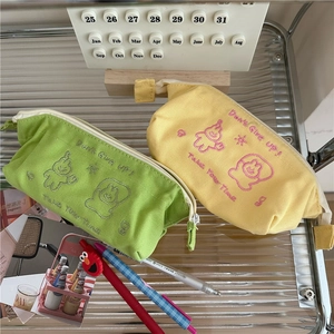 Japanese style canvas pencil cases in yellow and green with cartoon embroidery and zippers