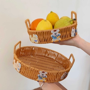 Detail of woven rattan baskets with cute cartoon bear and cat patches held by hands