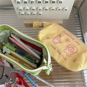 Detail view of large capacity canvas pencil cases with cartoon embroidery and open storage