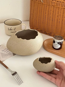 Macro detail of eggshell ceramic bowls with artistic irregular edges and matte texture
