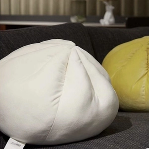 Detailed view of plush dumpling pillow showing soft fabric texture and pleated craftsmanship