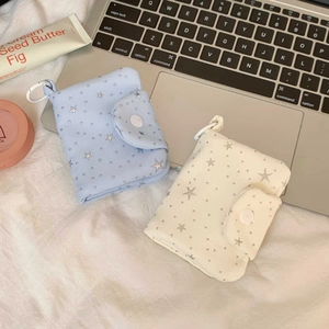 Detail of star-patterned quilted mini pouches with snap closure and portable D-ring hook
