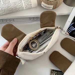Top view of an open large-capacity canvas pencil case showing interior storage details