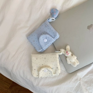 Detailed view of mini multi-layer star pattern pouches with heart and bunny charms
