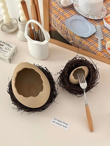 Detailed view of creative eggshell ceramic bowls with natural texture and bird nest bases