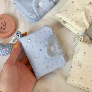 Close-up of star pattern fabric mini coin purse with heart charm and snap closure