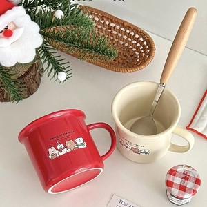 Christmas ceramic mug set with red and beige cups and spoons in a festive holiday scene