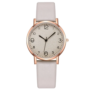 Detailed macro view of rose gold watch case with purple leather strap and numeric dial
