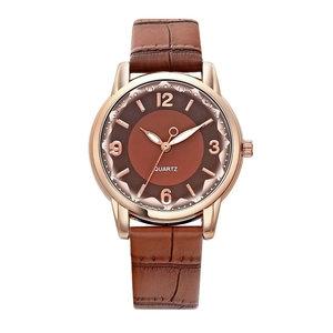 Detailed close-up of brown crocodile pattern leather strap and rose gold quartz watch