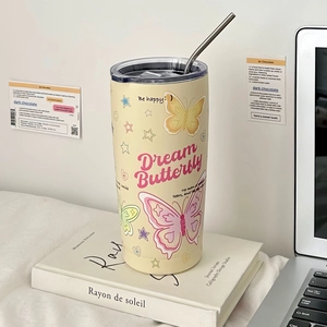 Close-up of cream stainless steel coffee cup with butterfly patterns and metal straw