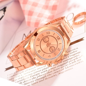 Elegant rose gold quartz watch with metal link strap and circular dial on a magazine